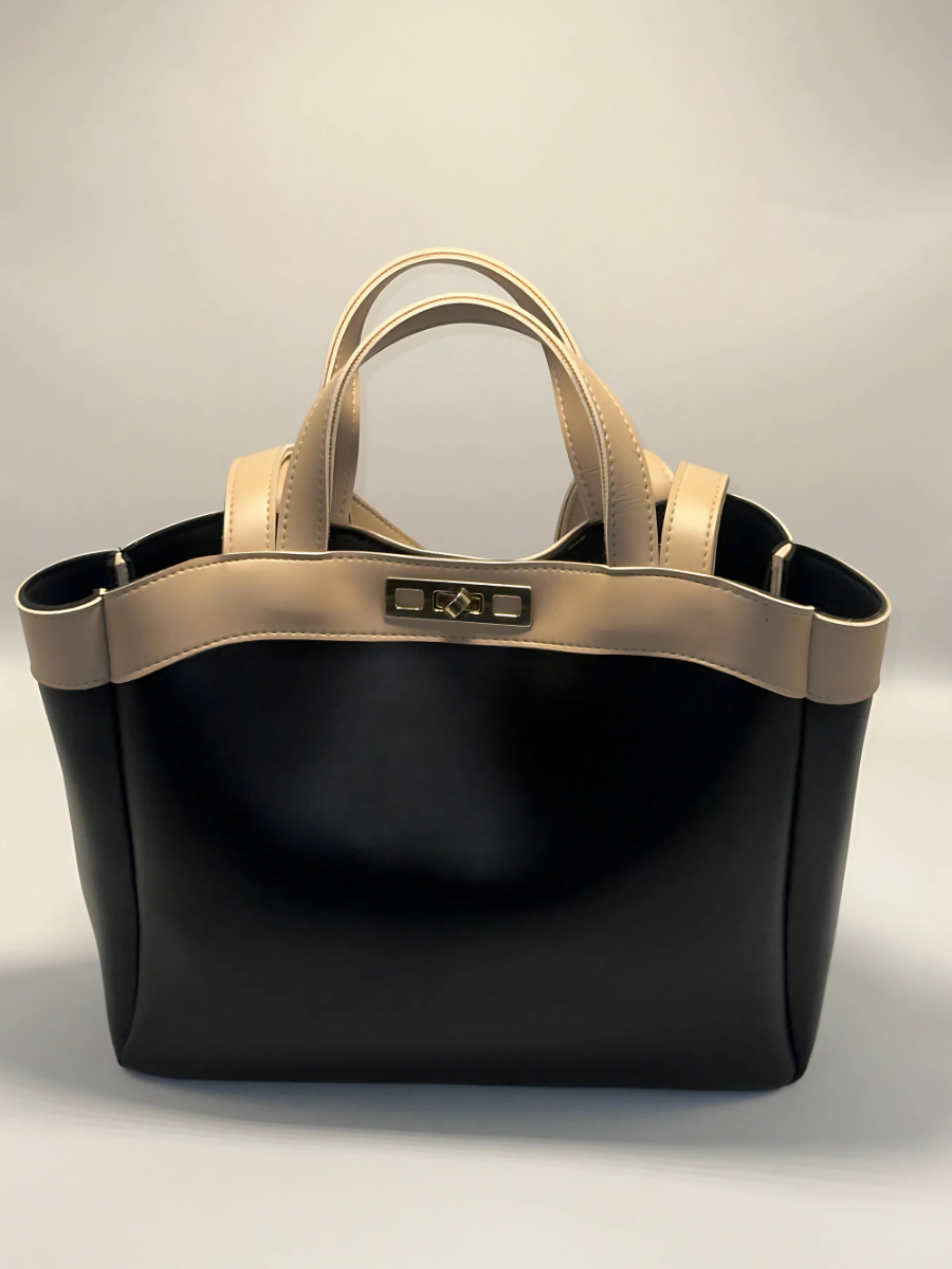 Stylish black and beige handbag with double handles and gold-tone hardware