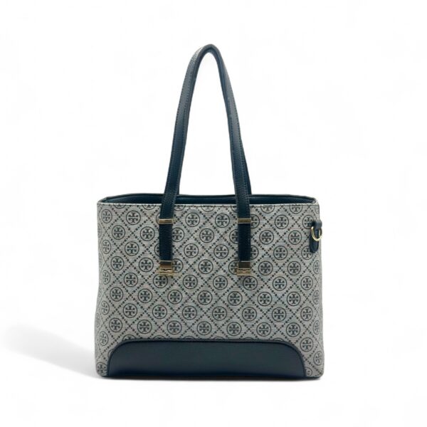 Elegant Tory Burch handbag with a signature pattern and black leather detailing