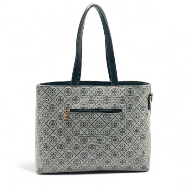 Elegant Tory Burch handbag with a signature pattern and black leather detailing.